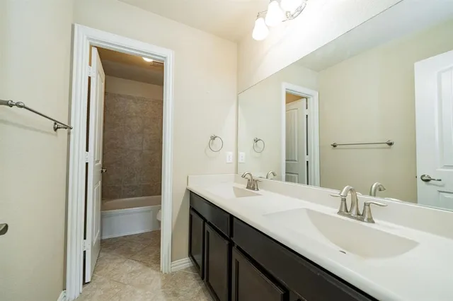 an empty room with a window and a ceiling fan