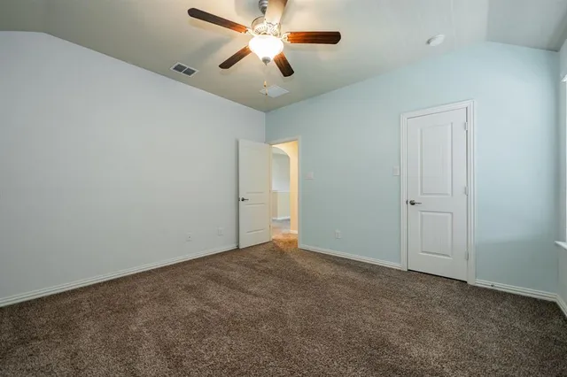 a view of room with a ceiling fan