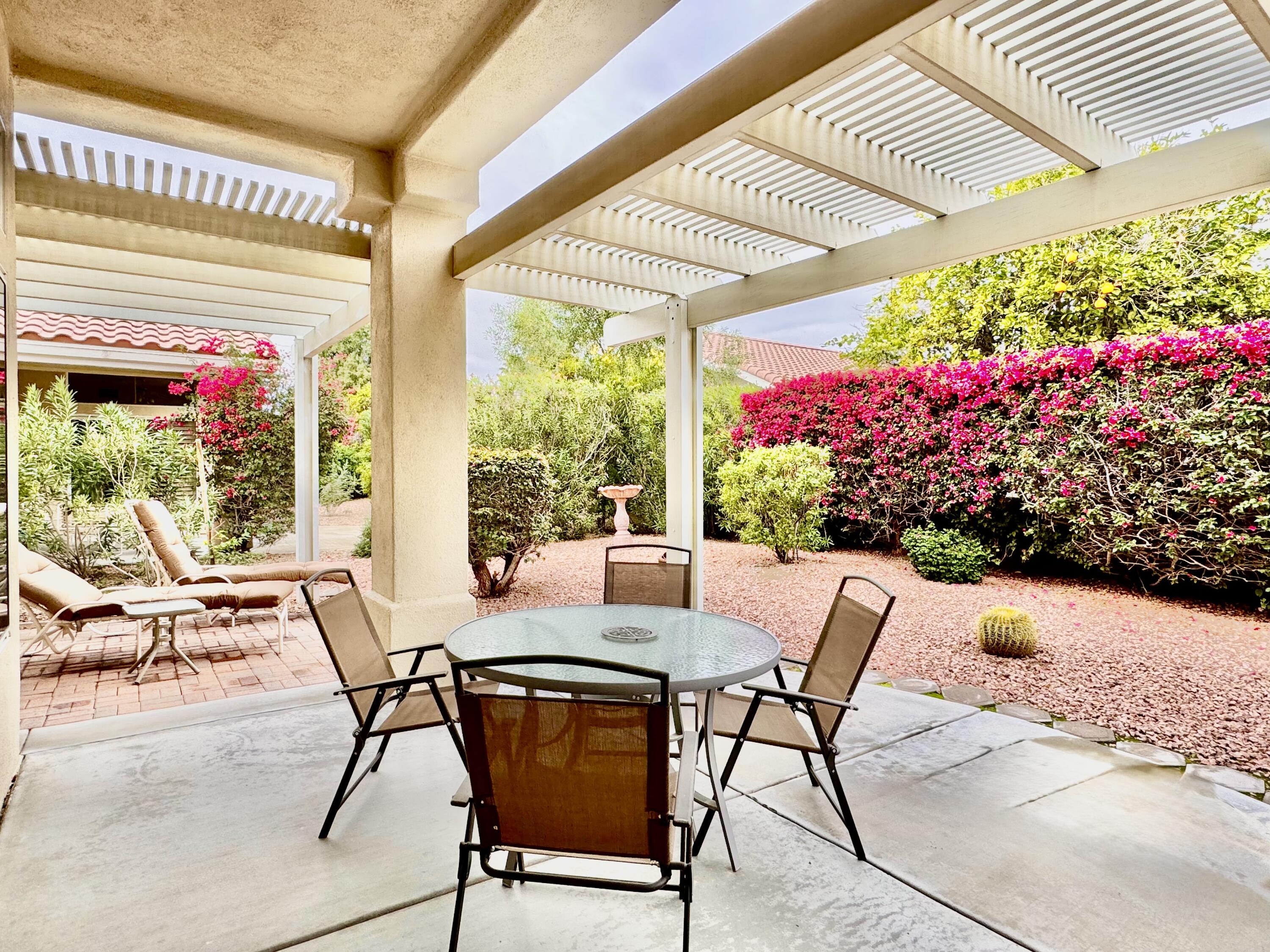 78376 Moongold Road Palm Desert, CA 92211 - Photo 16 of 36 a view of an outdoor dining space with a table and chairs