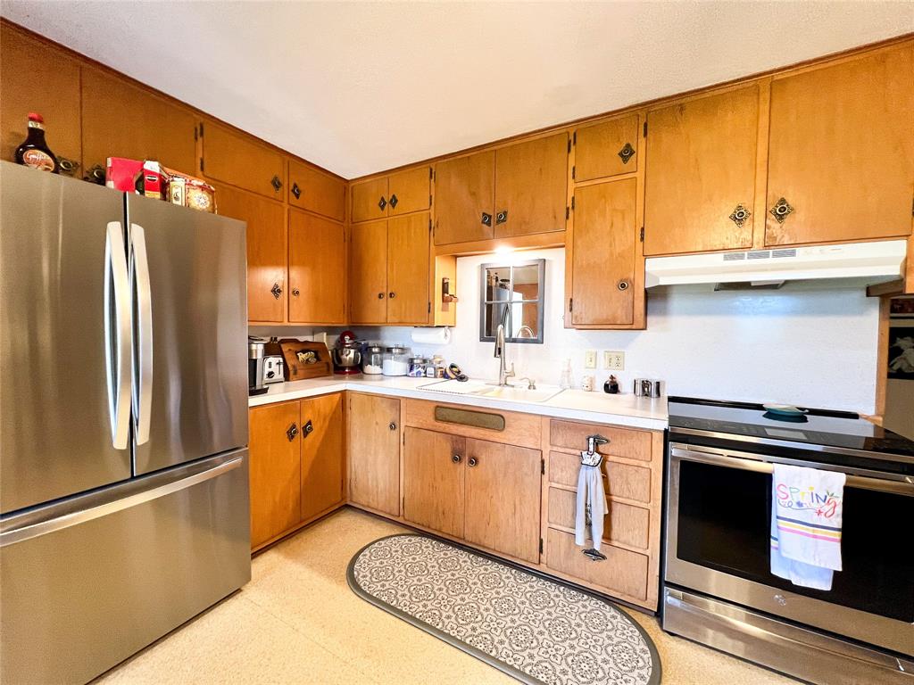 1009 North 7th Street Haskell, TX 79521 - Photo 11 of 26 a kitchen with stainless steel appliances granite countertop a refrigerator sink and cabinets