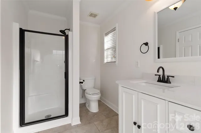a bathroom with a granite countertop sink a toilet a tub and mirror