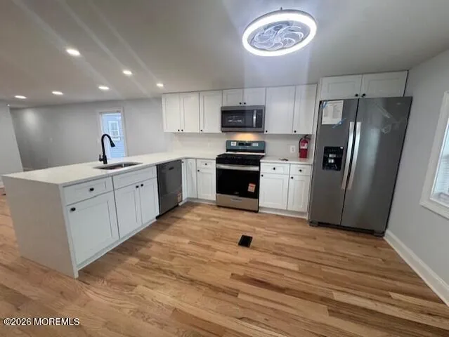 a large kitchen with stainless steel appliances granite countertop a stove a sink and a refrigerator