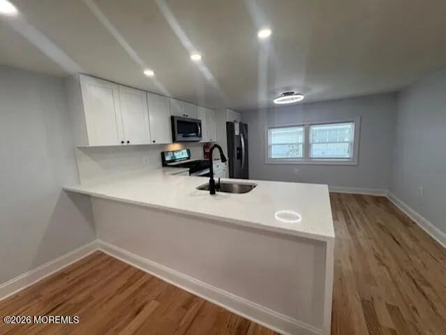 a view of a kitchen with a sink and a microwave