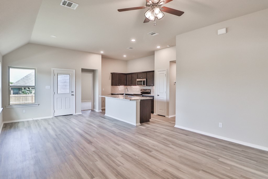 2871 Messenger Way Bryan, TX 77803 - Photo 5 of 13 an open kitchen with a refrigerator and a stove top oven