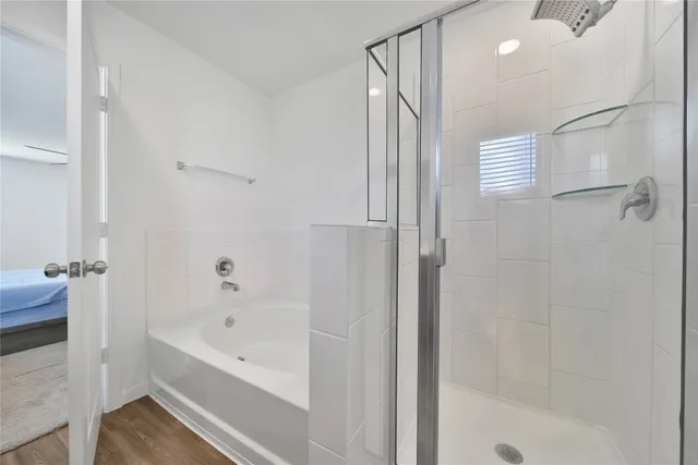 a bathroom with a bathtub and a shower