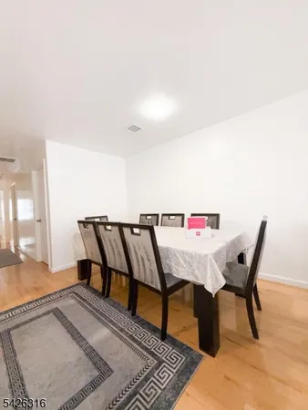 a view of a hallway with furniture and a rug