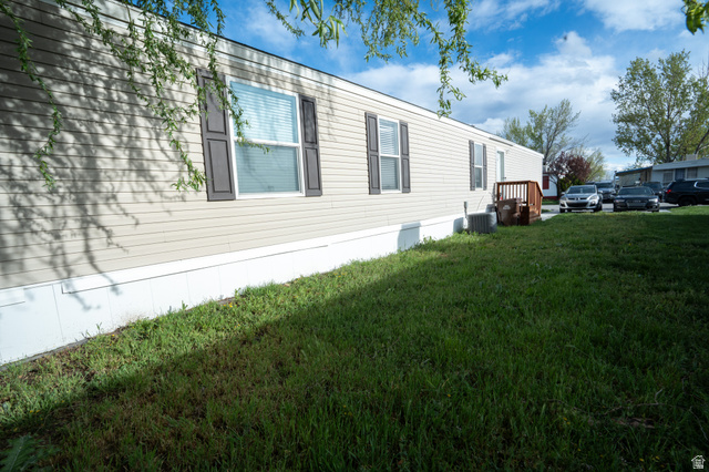 2491 Highway 89, Unit 111 Pleasant View, UT 84404 - Photo 20 of 20 View of property exterior featuring a lawn