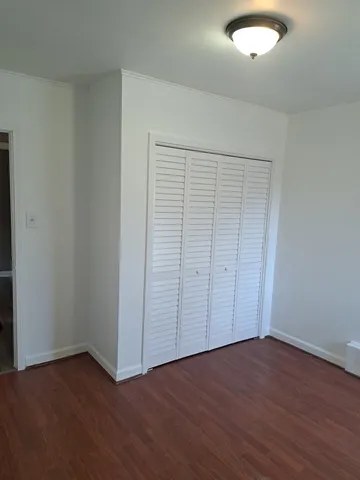 an empty room with wooden floor