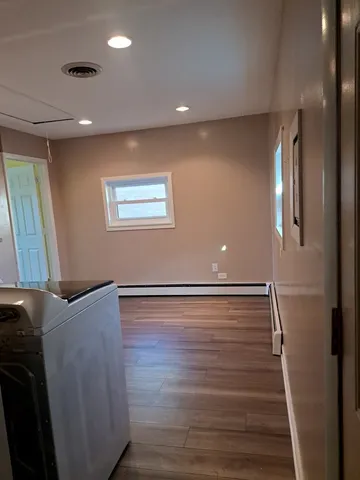 a view of a room with wooden floor and staircase