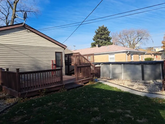 a backyard of a house with yard and outdoor seating