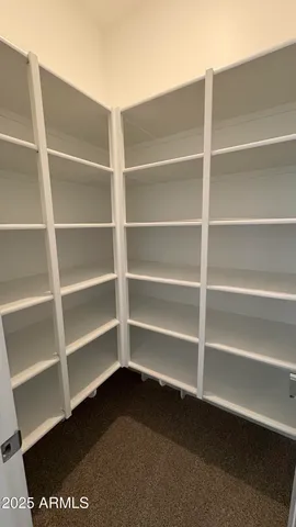 a bathroom with a granite countertop sink and a toilet