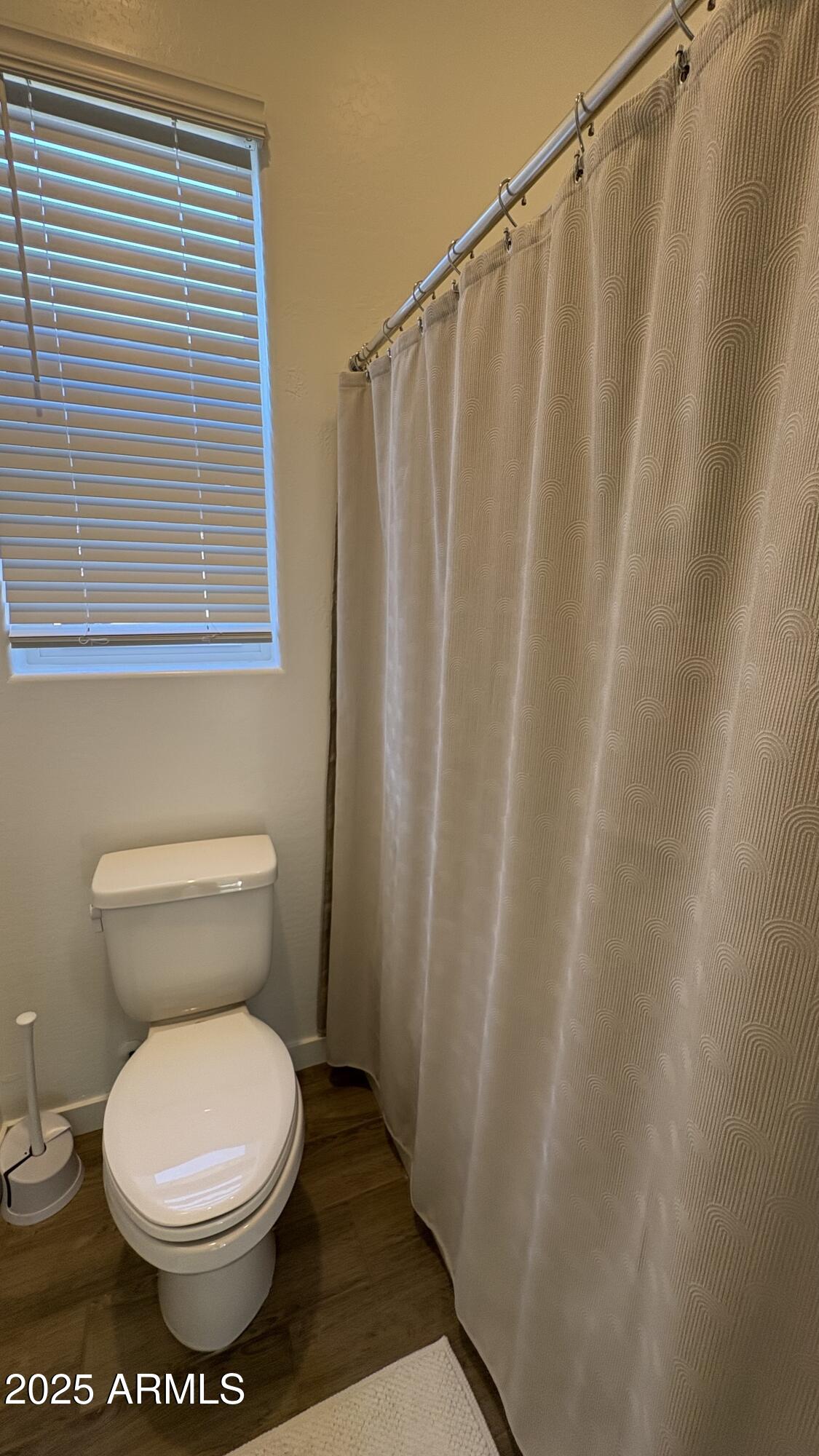 3240 West Peak View Road Phoenix, AZ 85083 - Photo 28 of 37 a bathroom with a toilet and a shower curtain