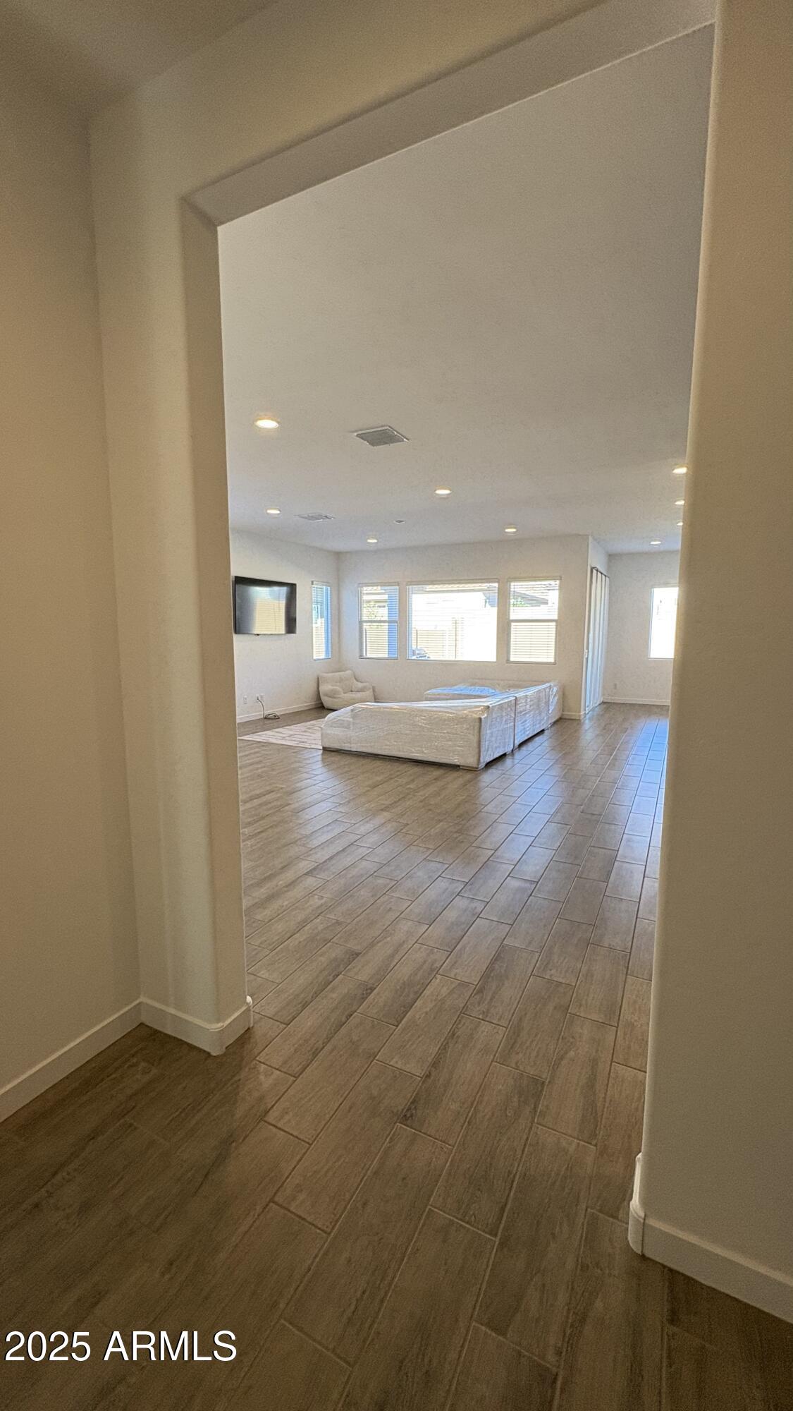 3240 West Peak View Road Phoenix, AZ 85083 - Photo 3 of 37 a view of empty room with wooden floor