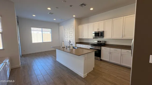 a kitchen with granite countertop white cabinets and white appliances