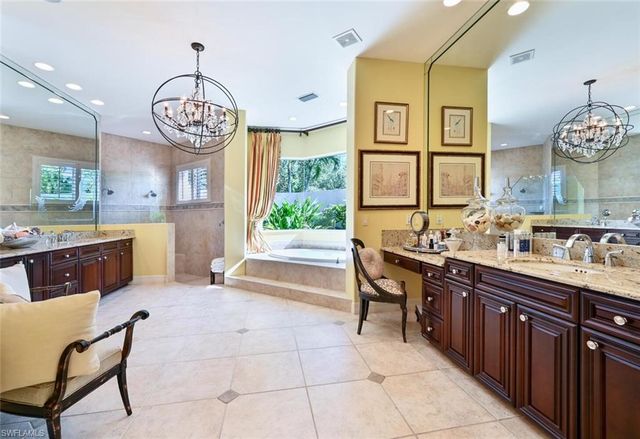 a large kitchen with a table and a view of living room