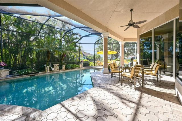 a view of a patio with a table chairs and garden