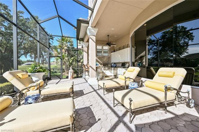 a living room with patio furniture and a floor to ceiling window