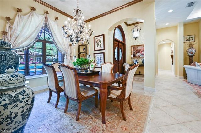 a view of a dining room with furniture and chandelier