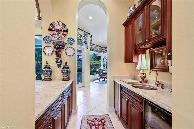 a hallway with a stove a sink and dishwasher