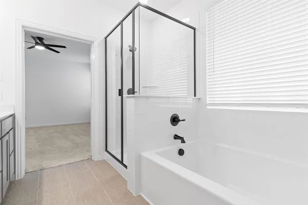 a bathroom with a bathtub and a shower