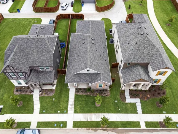 an aerial view of a house with a yard