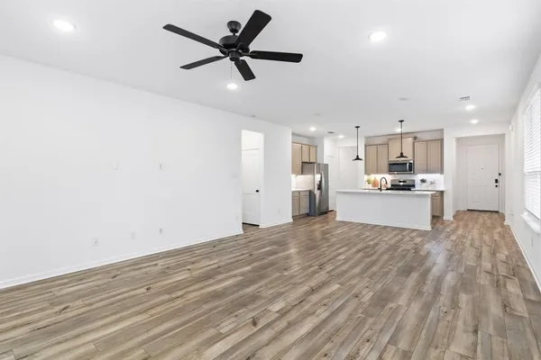 a view of kitchen with wooden floor and window