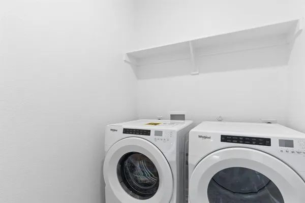 a view of storage and utility room with washer and dryer
