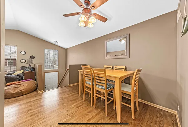 a dining room with furniture and wooden floor