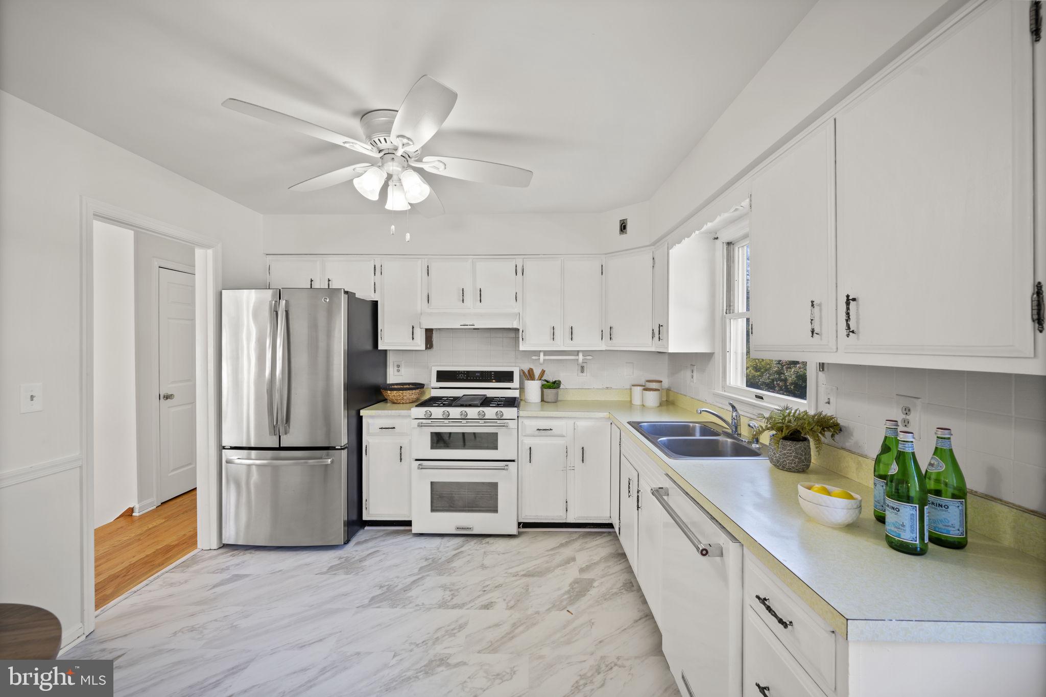 2502 Fox Road Fallston, MD 21047 - Photo 14 of 59 a kitchen with a refrigerator a stove top oven a sink and cabinets