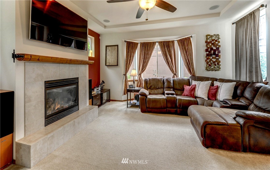 22921 42nd Drive Southeast Bothell, WA 98021 - Photo 12 of 38 a living room with furniture a fireplace and a flat screen tv