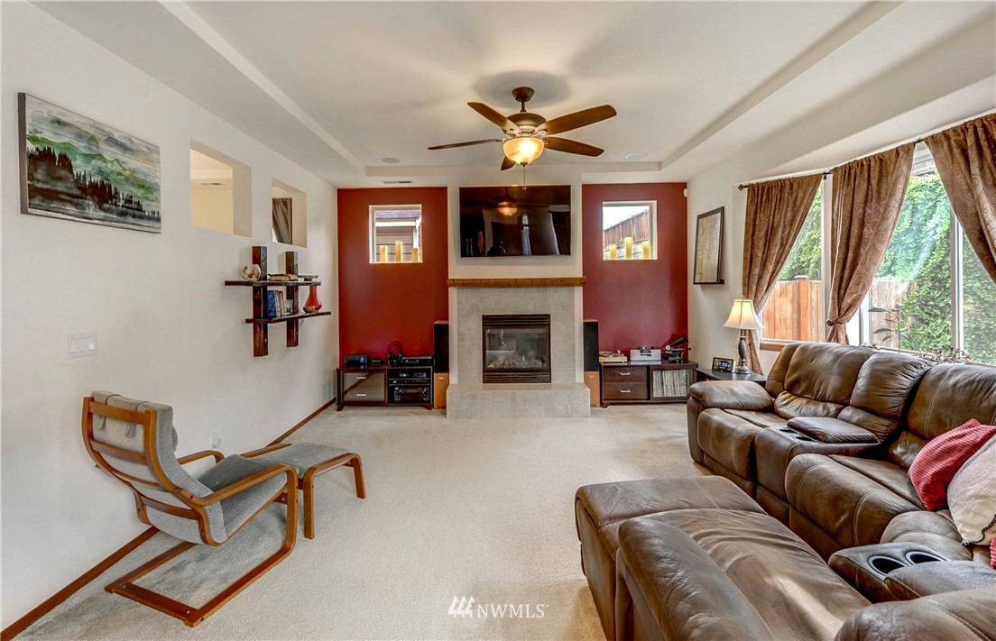 22921 42nd Drive Southeast Bothell, WA 98021 - Photo 13 of 38 a living room with furniture a fireplace and a large window