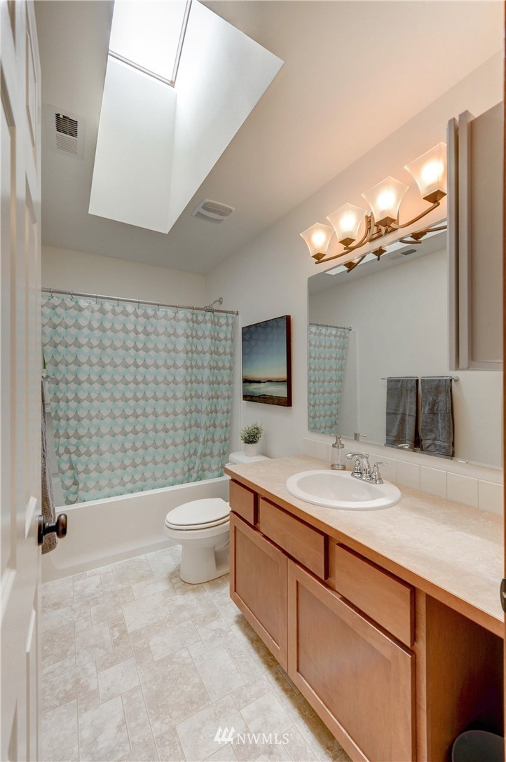 22921 42nd Drive Southeast Bothell, WA 98021 - Photo 19 of 38 a bathroom with a toilet a sink and a mirror