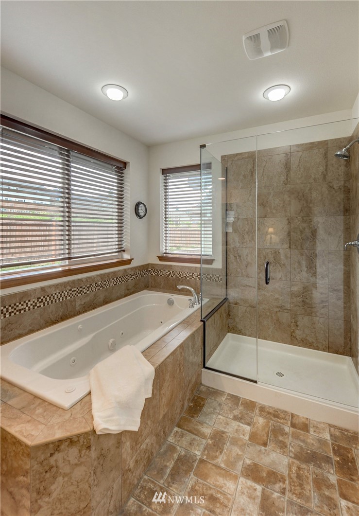 22921 42nd Drive Southeast Bothell, WA 98021 - Photo 27 of 38 a bathroom with a granite countertop bathtub and a shower