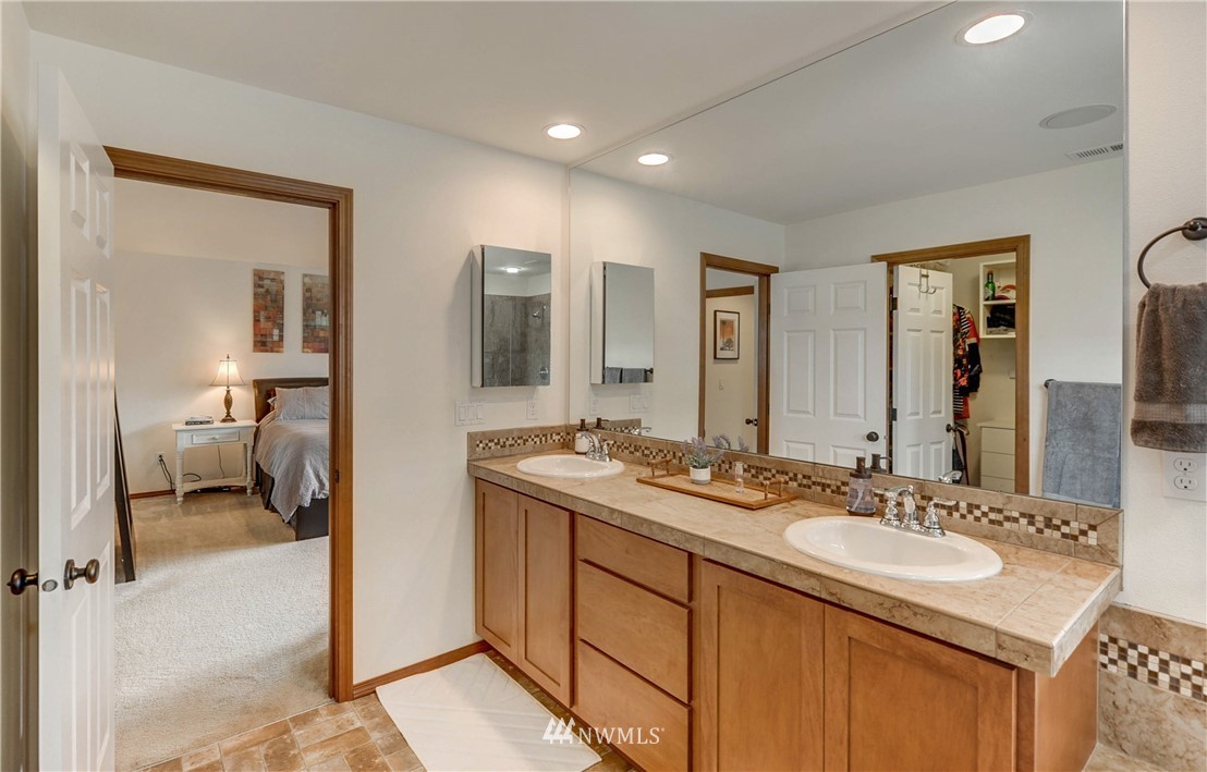 22921 42nd Drive Southeast Bothell, WA 98021 - Photo 28 of 38 a en suite bathroom with a sink double vanity and a mirror