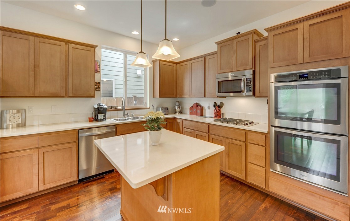 22921 42nd Drive Southeast Bothell, WA 98021 - Photo 5 of 38 a kitchen with stainless steel appliances a stove sink microwave and cabinets