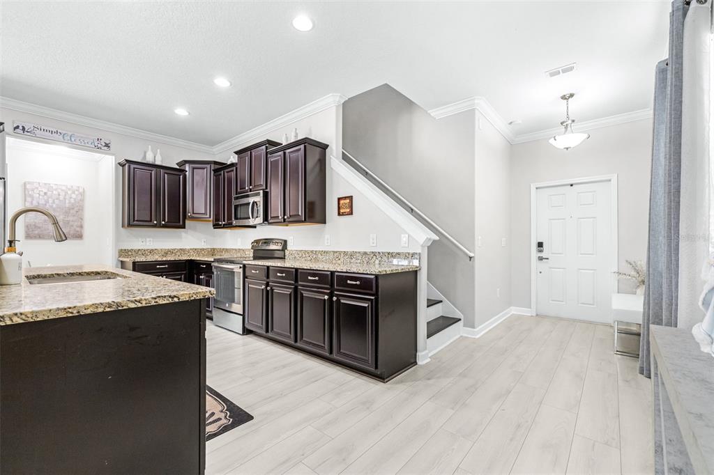 1762 Hadden Hall Place Trinity, FL 34655 - Photo 11 of 49 a kitchen with stainless steel appliances granite countertop a sink stove and refrigerator