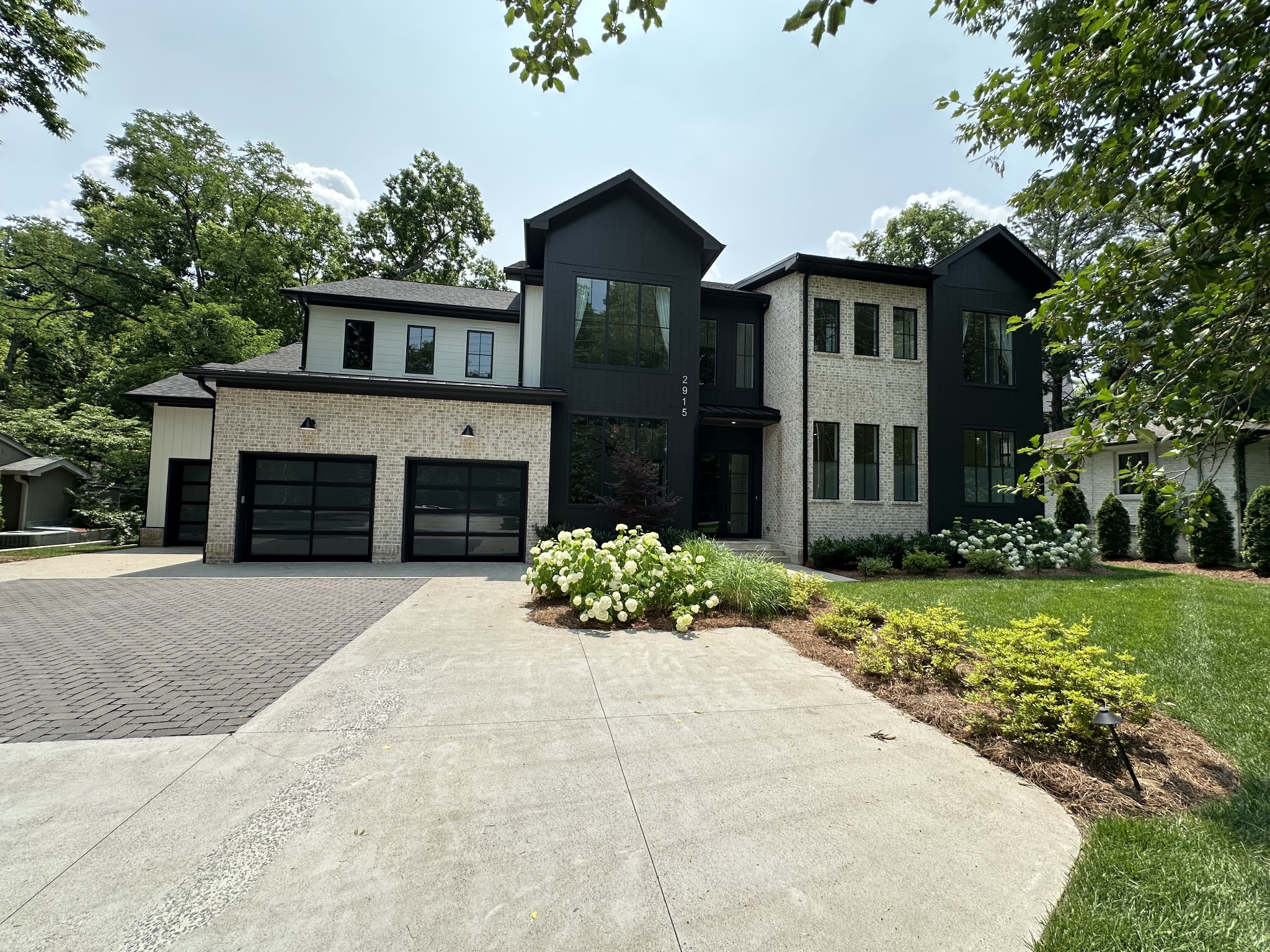 2915 Compton Road Nashville, TN 37215 - Photo 74 of 75 a front view of a house with a garden and trees