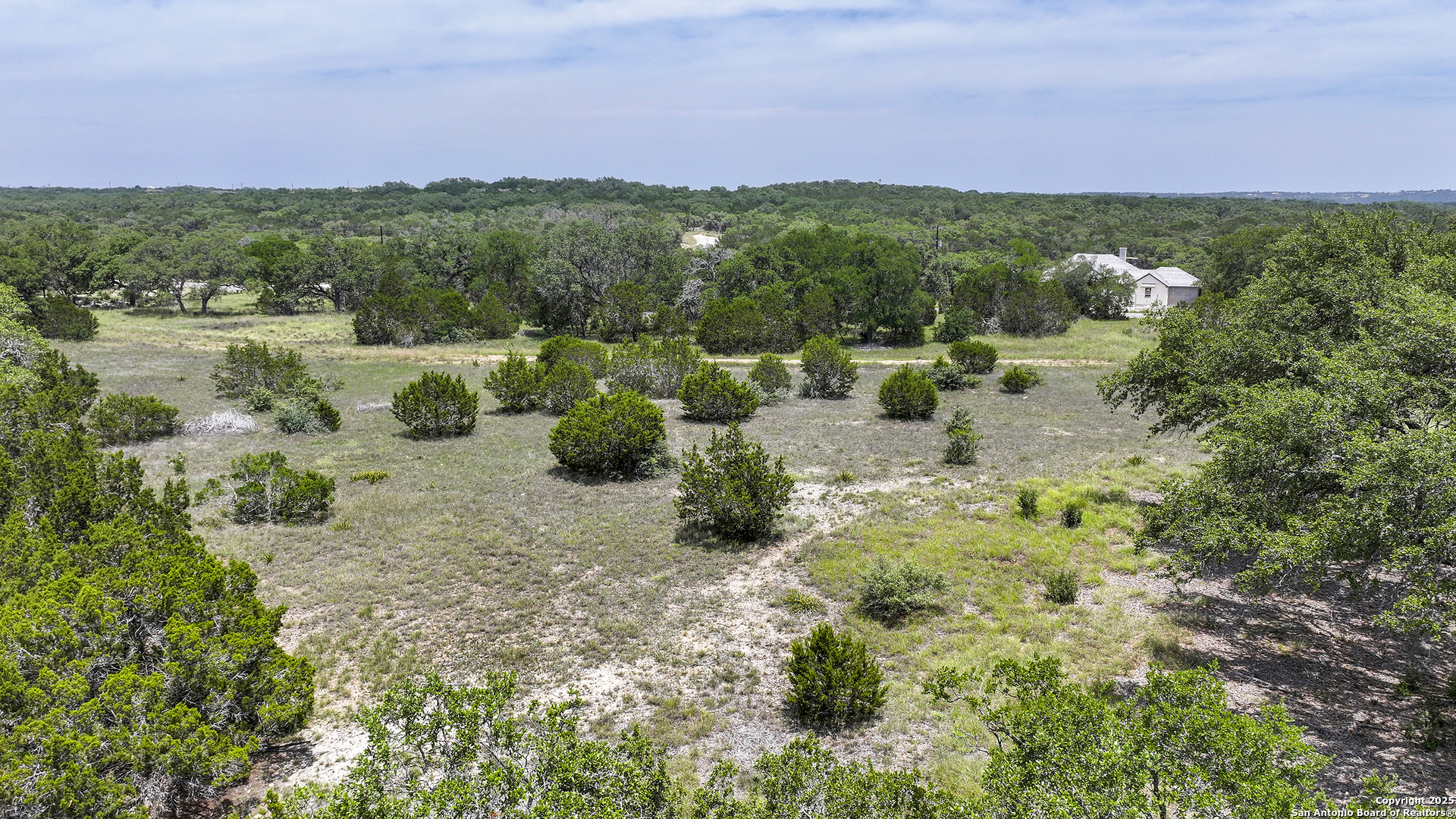 314 Serenity Pass Spring Branch, TX 78070 - Photo 22 of 26 a view of a lake with couches under an umbrella