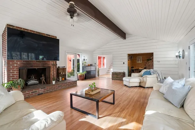 a living room with furniture fireplace and flat screen tv
