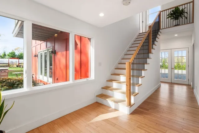 a view of entryway with wooden floor and stairs