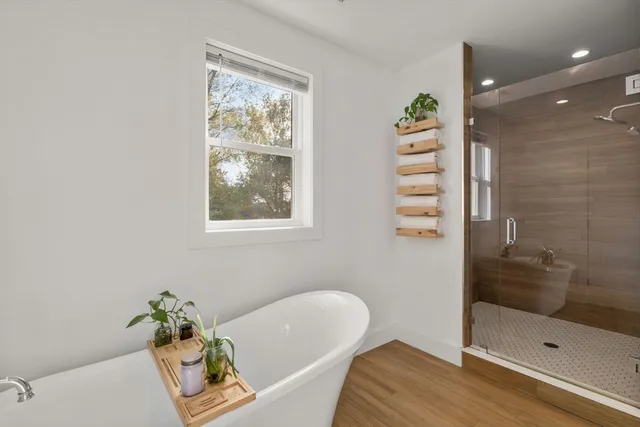 a bathroom with a tub and shower