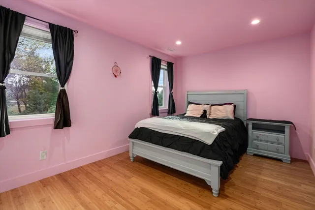 a bedroom with a bed and a window