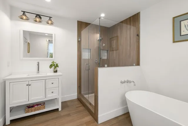 a bathroom with a bathtub shower sink and toilet