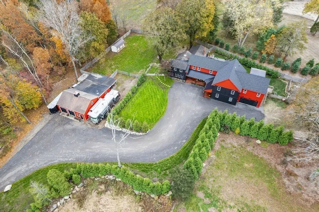 an aerial view of a house with a yard basket ball court