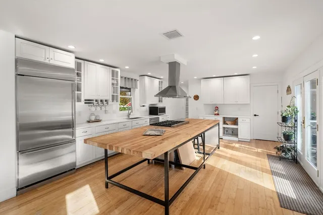 a kitchen with stainless steel appliances granite countertop a stove and a refrigerator