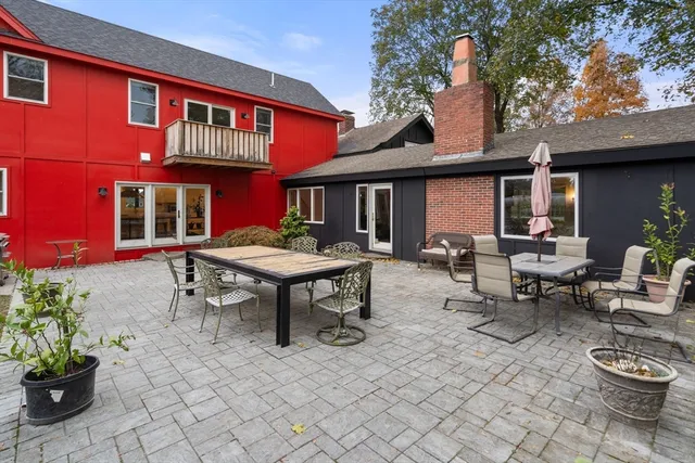 a backyard of a house with outdoor seating