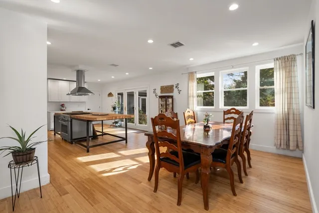 a view of a dining room with furniture window and wooden floor