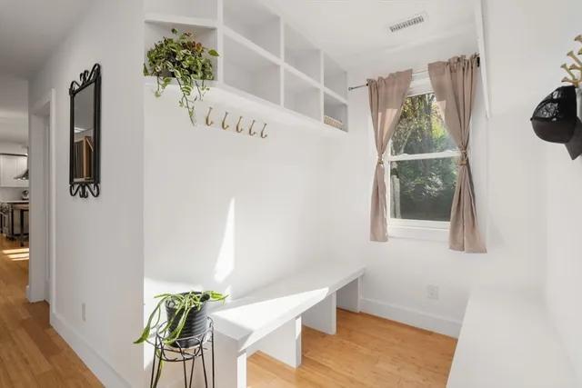 a view of an entryway with wooden floor