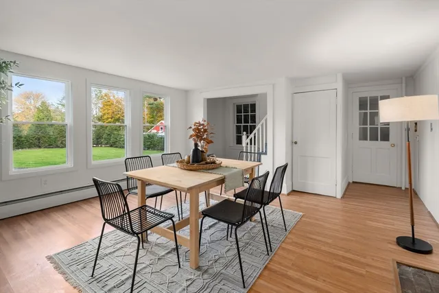 a view of a dining room with furniture window and wooden floor