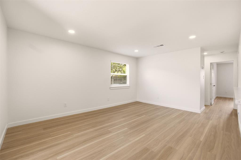 908 Isbell Road, Unit A Fort Worth, TX 76114 - Photo 14 of 28 Spacious room featuring wood-finish flooring, recessed lighting, a single window with blinds, and white baseboards